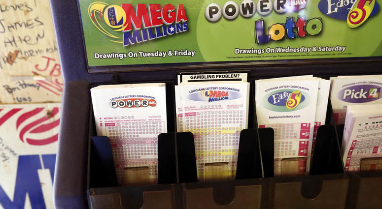 In this Tuesday, Oct. 23, 2018 file photo, lottery forms for Louisiana Mega Millions, Powerball and other lottery games fill the drawer at The World Bar and Grill, in Delta, La., lotto tickets Powerball