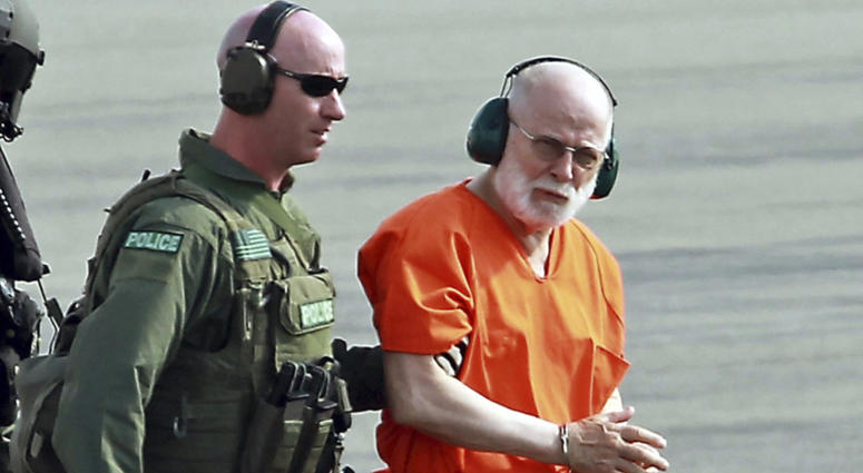 FILE - In this June 30, 2011 file photo, James "Whitey" Bulger, right, is escorted from a U.S. Coast Guard helicopter to a waiting vehicle at an airport in Plymouth, Mass., after attending hearings in federal court in Boston. Whitey Bulger