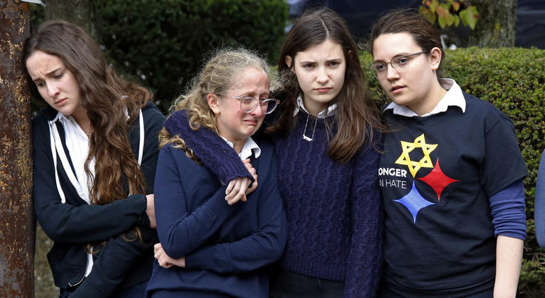 Students from the Yeshiva School in the Squirrel Hill neighborhood of Pittsburgh, pay their respects as the funeral procession for Dr. Jerry Rabinowitz passes their school en route to Homewood Cemetery following a funeral service at the Jewish Community C Pittsburgh synagogue funerals