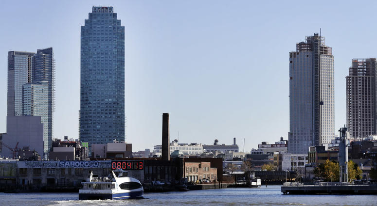 In this Nov. 7, 2018 file photo, a water taxi approaches the Long Island City waterfront and skyline, in the Queens borough of New York. Long Island City Amazon