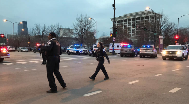 Chicago Police officers walk outside Mercy Hospital on the city's South Side where authorities say a shooting at the hospital has wounded multiple people, including a suspect and a police officer, Monday, Nov. 19, 2018, in Chicago. Chicago Shooting