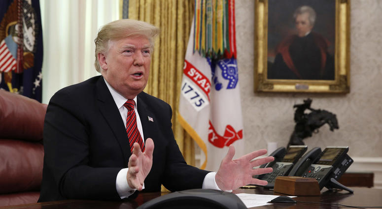 President Donald Trump greets members of the five branches of the military by video conference on Christmas Day, Tuesday, Dec. 25, 2018, in the Oval Office of the White House. Donald Trump Oval Office