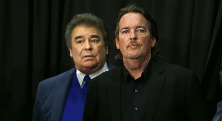 In this April 22, 2016 file photo, Democratic presidential candidate Hillary Clinton's brothers Tony Rodham, right, and Hugh Rodham, stand before she speaks at a campaign stop in Dunmore, Pa. Tony Rodham