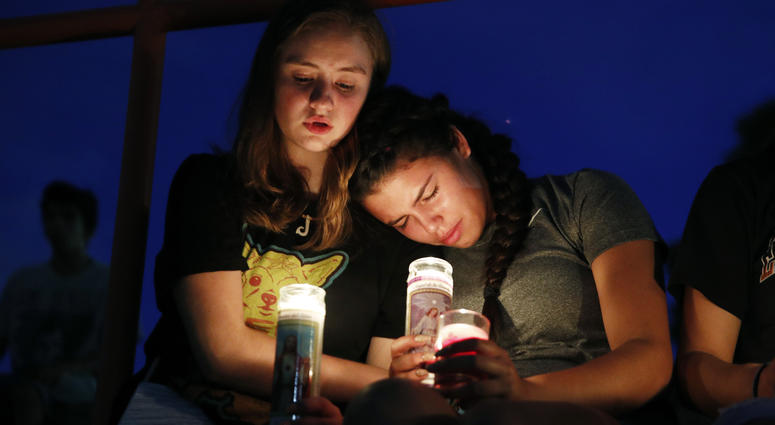 Melody Stout and Hannah Payan comfort each other during a vigil for victims of the shooting that occurred earlier in the day at a shopping center, Saturday, Aug. 3, 2019, in El Paso, Texas. El Paso Shooting