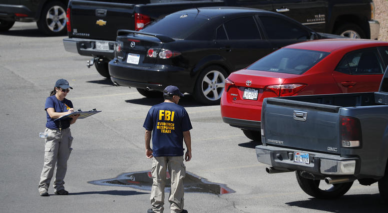 Members of the FBI evidence response team investigate the scene of a mass shooting at a shopping complex Sunday, Aug. 4, 2019, in El Paso, Texas. El Paso shooting
