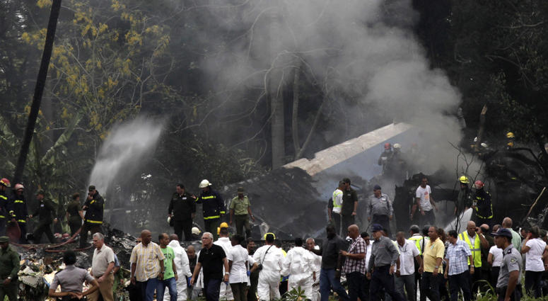 Cuba's President Miguel Diaz-Canel, third from left, walks away from the site where a Boeing 737 plummeted into a yuca field with more than 100 passengers on board, in Havana, Cuba, Friday, May 18, 2018. Cuba's President Miguel Diaz-Canel, third from left, walks away from the site where a Boeing 737 plummeted into a yuca field with more than 100 passengers on board, in Havana, Cuba, Friday, May 18, 2018.