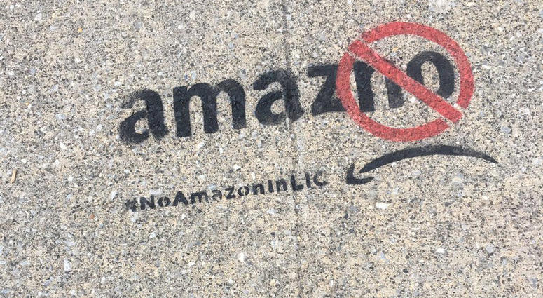 Anti-Amazon graffiti on a sidewalk in Long Island City. anti-Amazon Long Island City