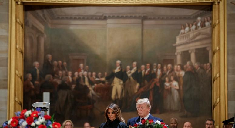 President Donald Trump and first lady Melania Trump pay their respects to former President George H.W. Bush as he lies in state in the U.S. Capitol Rotunda on December 3, 2018 in Washington, DC. George H.W. Bush