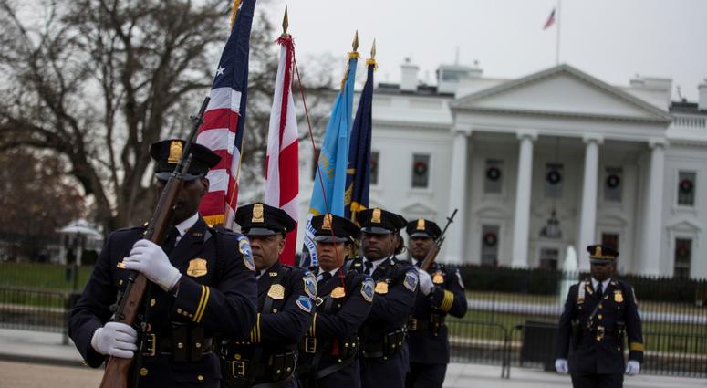 Honor Guard members depart after a hearse carrying the remains of former U.S. President George H.W. Bush passed the White House en route to the National Cathedral before a state funeral on December 5, 2018 in Washington, DC. George H.W. Bush