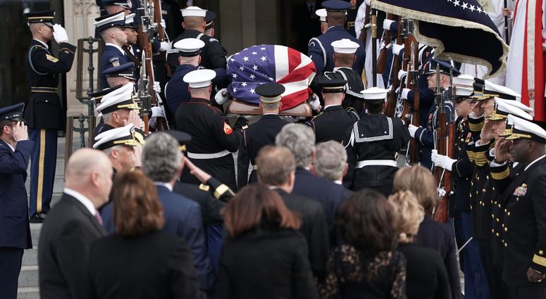 Followed by family members, a joint service honor guard carries the casket of former US President George H.W. Bush into the Washington National Cathedral on December 5, 2018 in Washington, DC. George H.W. Bush