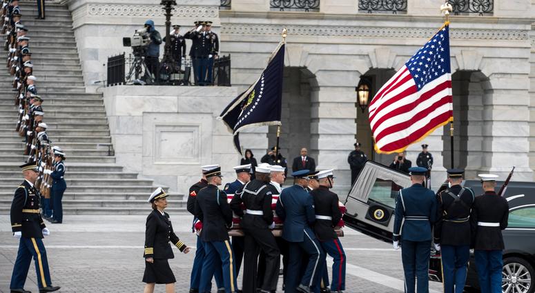 A joint services military honor guard carries the casket of former U.S. President George H. W. Bush from the U.S. Capitol to transport it to Washington National Cathedral for the state funeral on December 5, 2018 in Washington, DC. George H.W. Bush