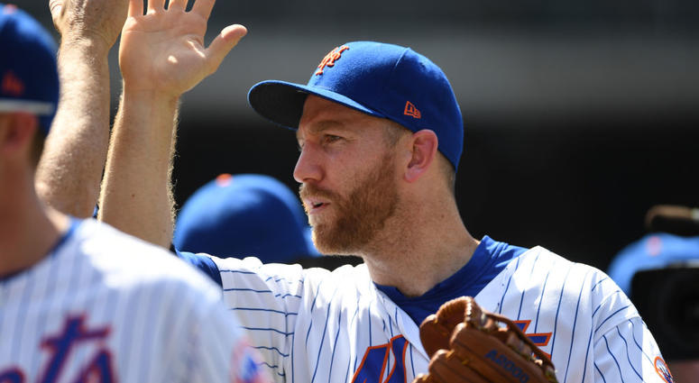 Todd Frazier #21 of the New York Mets high-fives his teammates after the New York Mets win 7-3 at Citi Field against the San Francisco Giants on June 06, 2019 Todd Frazier mets