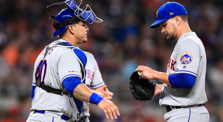 Wilson Ramos #40 speaks with Luis Avilan #43 of the New York Mets in the seventh inning during the game against the Atlanta Braves at SunTrust Park on August 13, 2019 Wilson Ramos #40 speaks with Luis Avilan #43 of the New York Mets in the seventh inning during the game against the Atlanta Braves at SunTrust Park on August 13, 2019