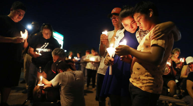 People attend a candlelight prayer vigil outside Immanuel Baptist Church, located near the scene of a mass shooting which left at least 22 people dead, on August 5, 2019 in El Paso, Texas. El Paso Shooting Vigil