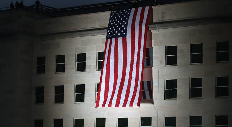 An American flag is unfurled on the side of the Pentagon to commemorate the anniversary of the 9/11 terror attacks September 11, 2019 in Arlington, Virginia. 9/11 Pentagon