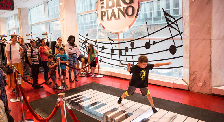Children play on the 'Big Piano,' made famous by the movie Big FAO Schwarz Big Piano