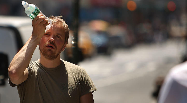 A man tries to cool himself with a bottle of water during the first heat wave of the year June 9, 2008 in New York City. Record Heat Wave