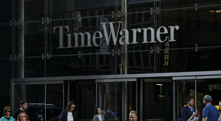 People walk past the Time Warner Center People walk past the Time Warner Center