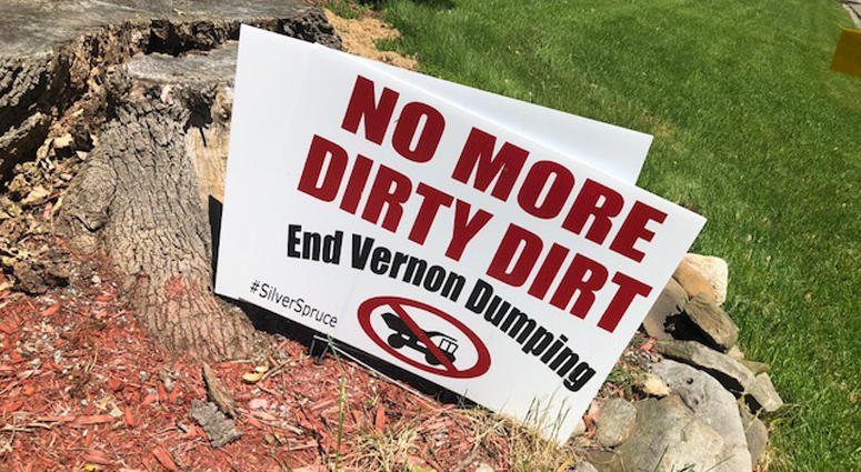 Signs protesting a growing dirt pile on private property in residential neighborhood in Vernon Vernon dirt pile