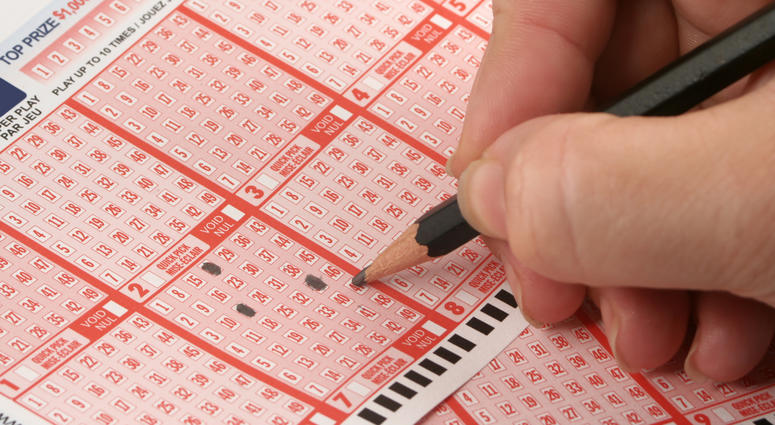 Person filling out lottery ticket Person filling out lottery ticket