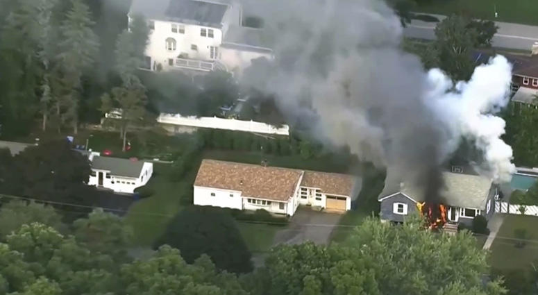 In this image take from video provided by WCVB in Boston, flames rise from a house in Lawrence, Mass, a suburb of Boston, Thursday, Sept. 13, 2018. Emergency crews are responding to what they believe is a series of gas explosions that have damaged homes. Massachusetts Gas Fires