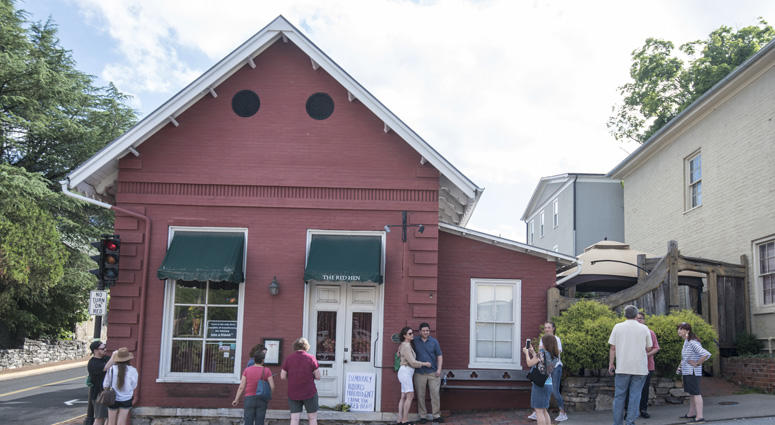 Passersby gather to take photos in front of the Red Hen Restaurant, Saturday, June 23, 2018, in Lexington, Va. Red Hen Restaurant