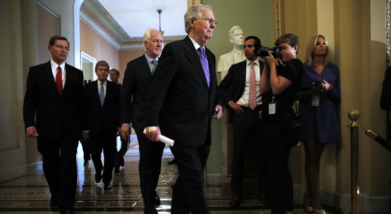 Senate Majority Leader Mitch McConnell of Ky., center, walks with members of Republican leadership, from left, Sen. John Barrasso, R-Wyo., Sen. Roy Blunt, R-Mo., Sen. John Thune, R-S.D., and Senate Majority Whip Sen. John Cornyn, R-Texas. Senate Republicans