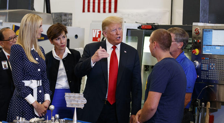 President Donald Trump participates in a tour of an advanced manufacturing lab with Ivanka Trump, second from left, and Gov. Kim Reynolds, R-Iowa, third from left, at Northeast Iowa Community College. President Donald Trump In Iowa