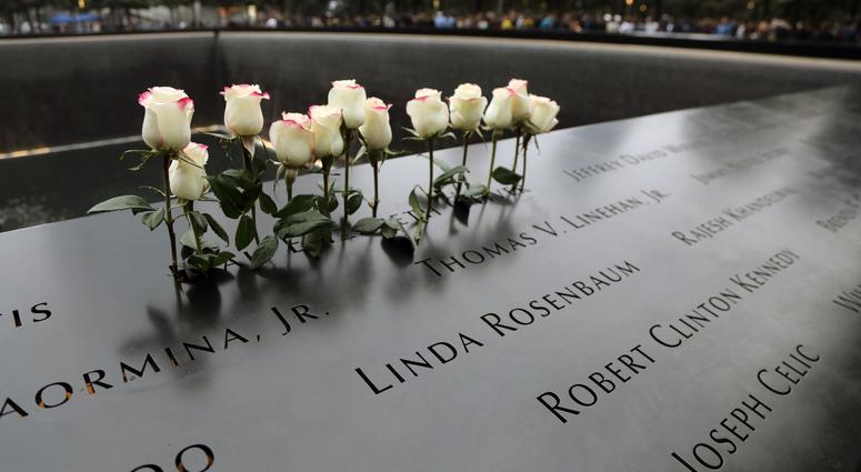 Flowers on the North Tower during ceremonies at the National September 11 Memorial observing the 17th anniversary of the attacks