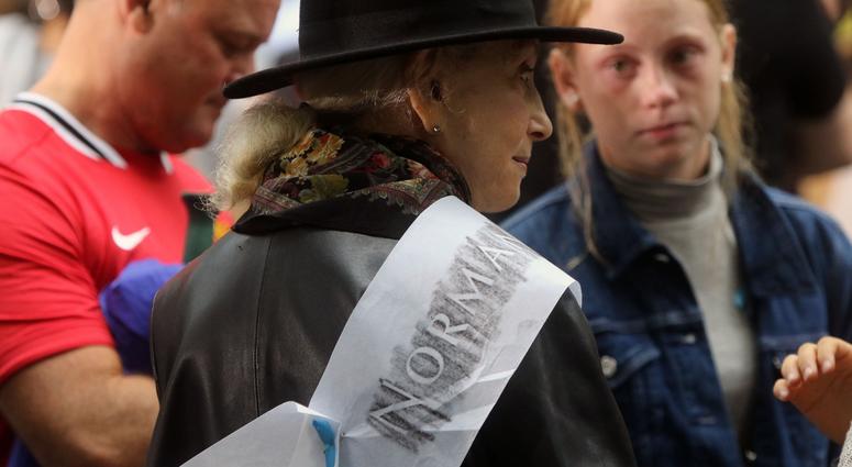 Ann Rossener with an etching for her son Norman who died on 9/11