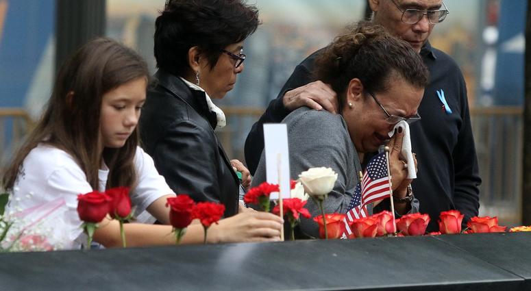 A woman is overcome with emotion at the North Tower Memorial during ceremonies at the National September 11 Memorial observing the 17th anniversary of the attacks that killed people in Manhattan