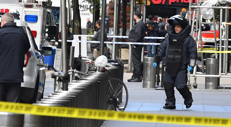 A member of the bomb squad at the Time Warner Center, where an explosive device was found. pipe bomb CNN device