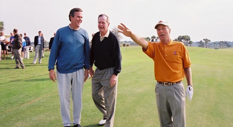 Ben Crenshaw, right, explains his errant shot on No. 17 to Gov. Jeb Bush, left, and former President George H.W. Bush, who paid a short visit Friday, Feb. 9, 2002, to the ACE Group Classic. George H.W. Bush