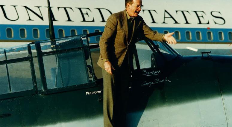 ice President/President-elect George H.W. Bush tosses a marker after naming the plane "Barbara" and signing his name underneath. George H.W. Bush