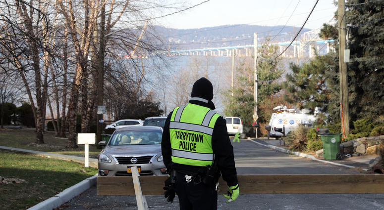A police officer stands on Van Wart Avenue as people head to the Riverwalk to get a view of the demolition of the eastern portion of the Tappan Zee Bridge Jan. 15, 2019 in Tarrytown. Tappan Zee Demolition