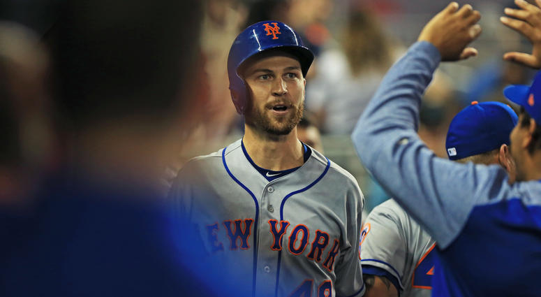 New York Mets starting pitcher Jacob deGrom (48) celebrates with teammates after hitting a solo home run in the third inning of the game against the Miami Marlins at Marlins Park. Jacob deGrom