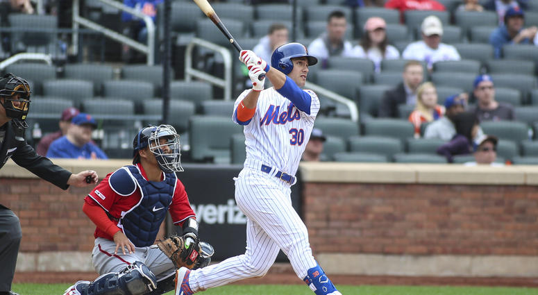 New York Mets right fielder Michael Conforto (30) hits a three run home run in the ninth inning against the Washington Nationals at Citi Field. Michael Conforto
