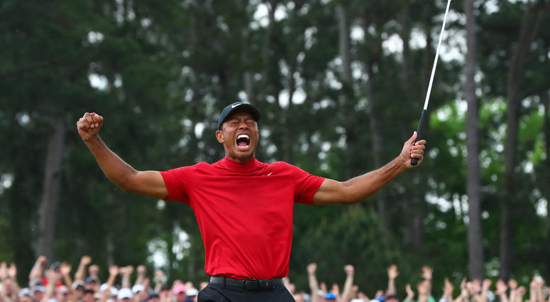 Tiger Woods celebrates after making a putt on the 18th green to win The Masters golf tournament at Augusta National Golf Club. Tiger Woods