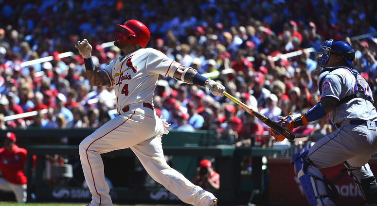 St. Louis Cardinals catcher Yadier Molina (4) hits a sacrifice RBI against the New York Mets during the third inning at Busch Stadium. Mets Cardinals