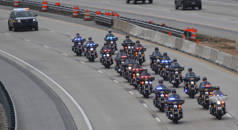 A motorcade carries the body of Marine Staff Sgt. Christopher Slutman, who was killed in a roadside bomb in Afghanistan, from the Dover Air Force Base to New York City on Monday morning. Firefighters Honor Fallen Marine