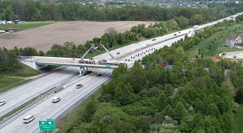 The funeral procession for Marine Staff Sergeant Christopher Slutman heads north along Rt. 1 past the Kentwood St. Georges Road overpass in St. Georges, DE, Monday, April 22, 2019. Firefighters Honor Fallen Marine