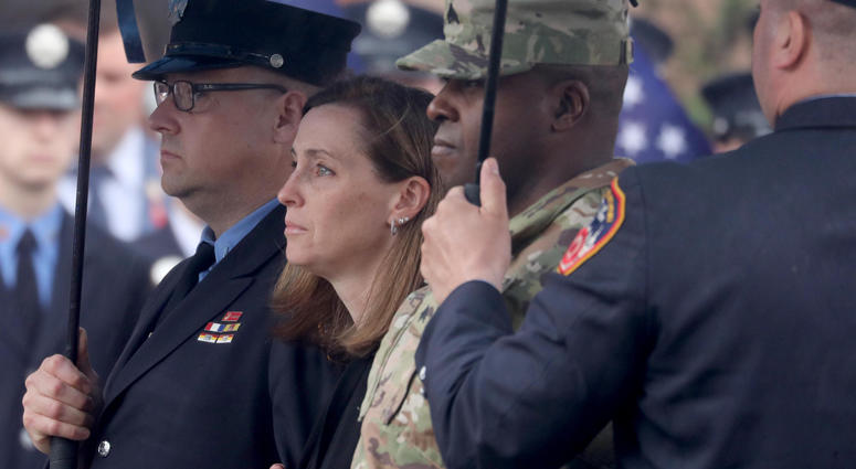 Shannon Slutman, the wife of FDNY member and U.S. Marine Christopher Slutman watches as her husband's casket is carried into the Joseph Lucchese Funeral Home in the Bronx April 21, 2019. Firefighters Honor Fallen Marine