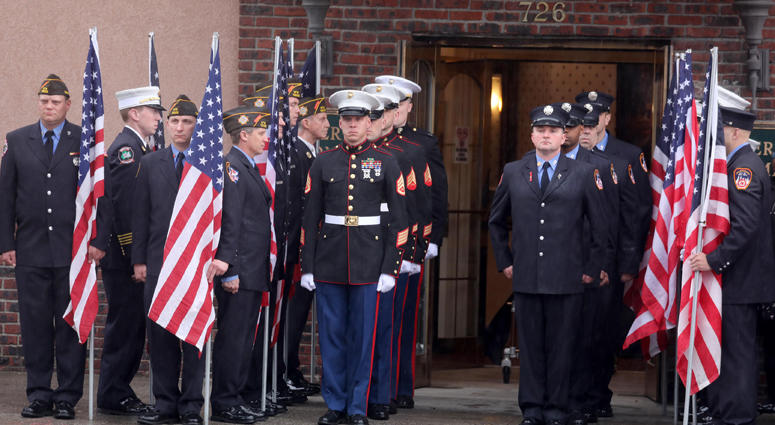 Members of the New York City Fire Department and U.S. Marine Corps stand at attention outside the Joseph Lucchese Funeral Home in the Bronx April 21, 2019. as the hearse containing the body of FDNY member and U.S. Marine Christopher Slutman arrives. Firefighters Honor Fallen Marine
