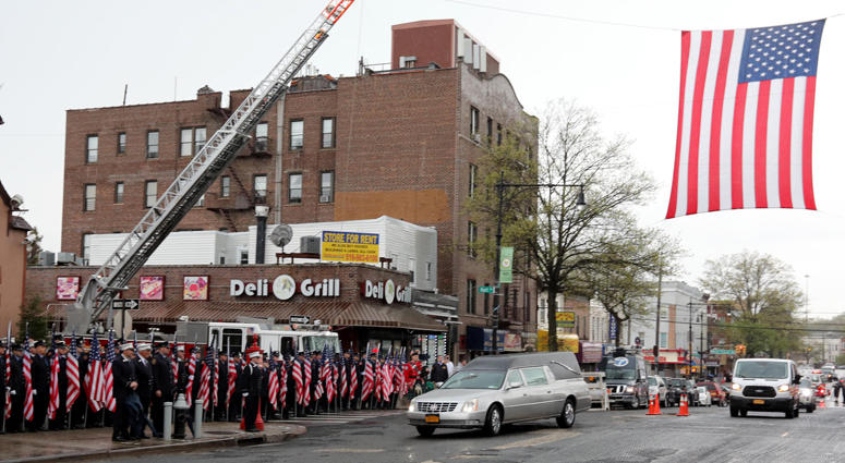 The hearse containing the body of FDNY member and U.S. Marine Christopher Slutman arrives at the Joseph Lucchese Funeral Home in the Bronx April 21, 2019. Firefighters Honor Fallen Marine