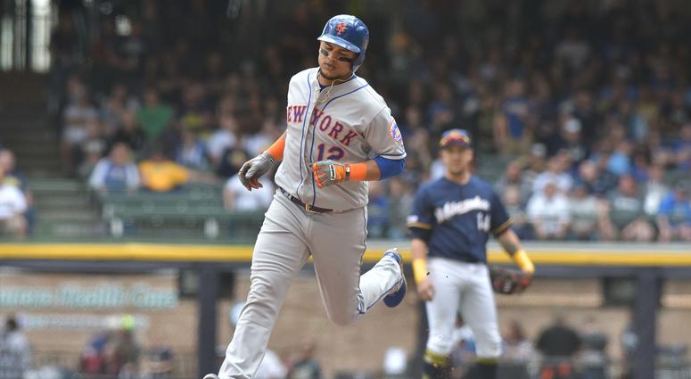New York Mets outfielder Juan Lagares (12) rounds the bases after hitting a home run against the Milwaukee Brewers in the seventh inning at Miller Park. Mets Brewers