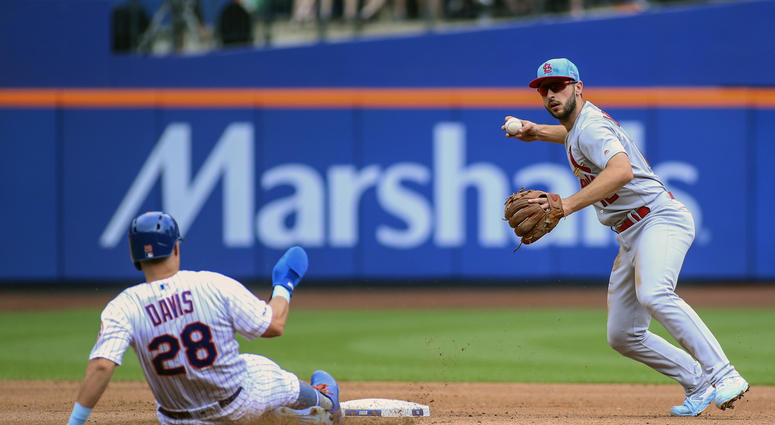 St. Louis Cardinals shortstop Paul DeJong (12) tries to turn a double play against New York Mets third baseman J.D. Davis (28) in the first inning at Citi Field. Cardinals Mets