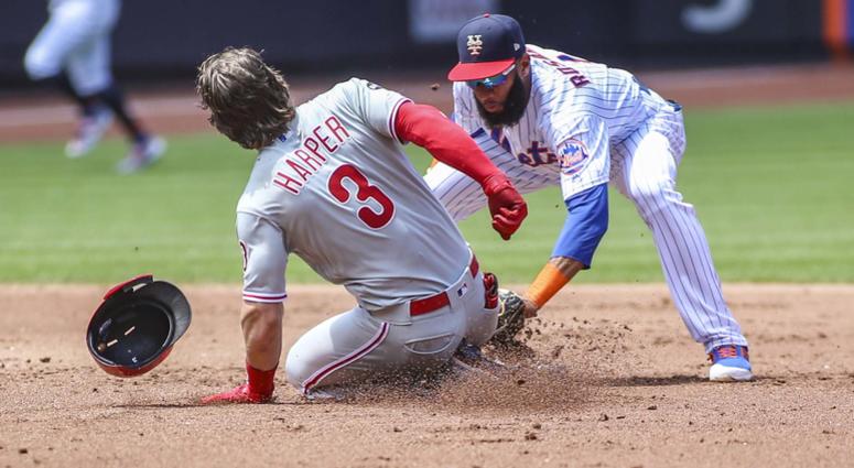 Philadelphia Phillies right fielder Bryce Harper (3) is tagged out at second base by New York Mets shortstop Amed Rosario (1) in the second inning at Citi Field. Mets Phillies
