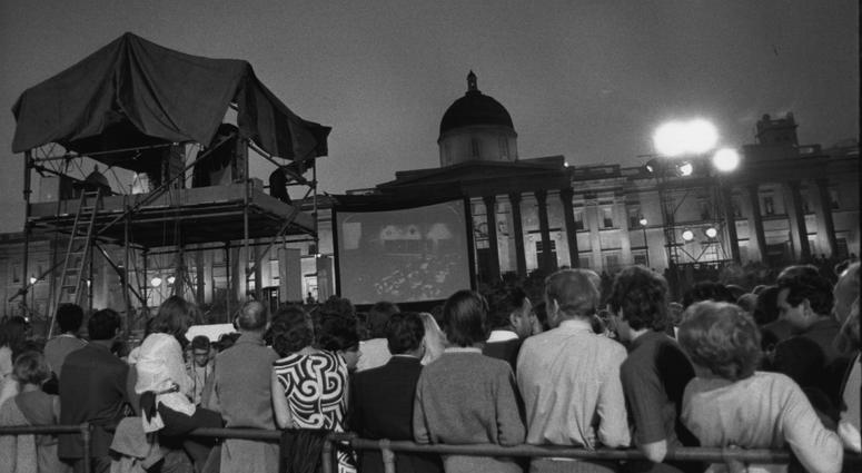 London Crowd Watching Landing Crowds watching pictures of the first landing on the moon on a large screen in Trafalgar Square, London.