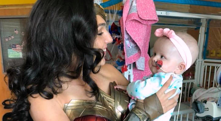 ``Wonder Woman'' star Gal Gadot visited children at a Virginia hospital wearing her iconic Amazonian armor costume from the superhero film. Gal Gadot