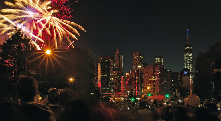 New Yorkers watch Macys Fireworks over the East River at Fulton Ferry Landing, Brooklyn New York, 2014. East River Fireworks